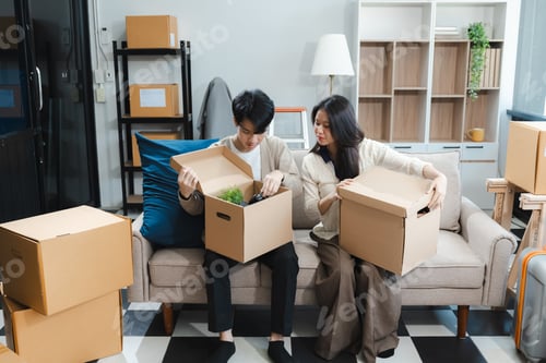 Preview: Young couple relaxing very happy moving to a new house.