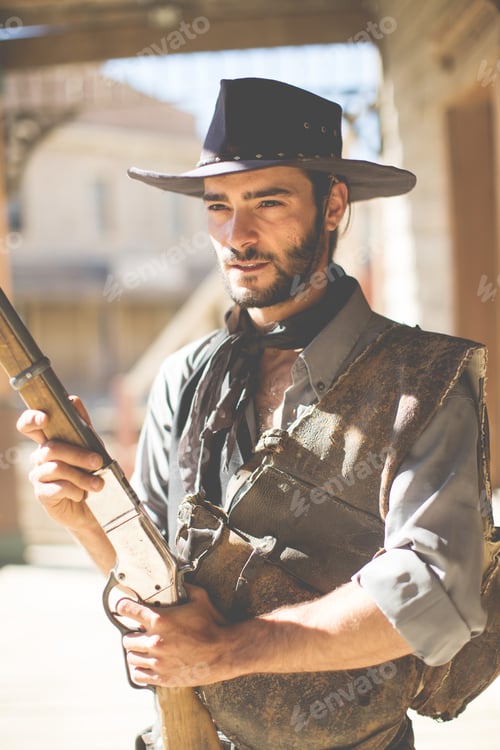 Preview: Cowboy holding up shotgun on wild west film set, Fort Bravo, Tabernas, Almeria, Spain