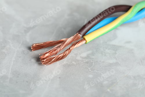 Preview: Colorful electrical wires on gray textured surface, closeup