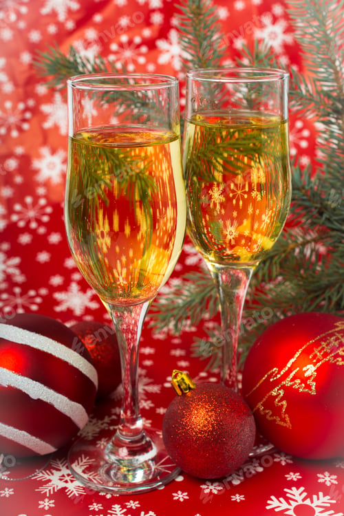 Preview: glasses of champagne and Christmas decorations