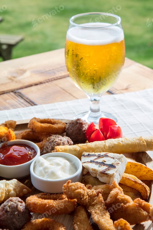 Preview: The beer plate with fries onion rings,on a wooden plate.