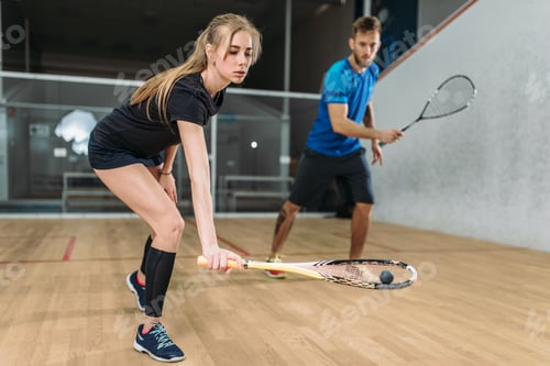 Preview: Couple with squash rackets, indoor training club