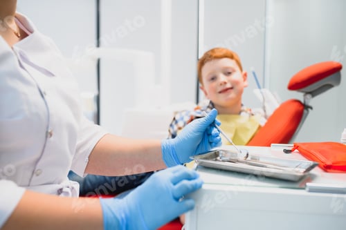 Preview: Portrait of a dentist holding dental instruments in his hands in the clinic close-up