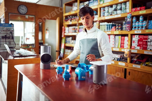 Preview: Salesman taking inventory of plumbing pipes and fittings in hardware store