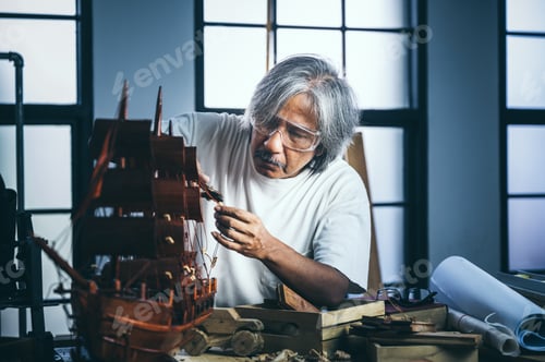 Preview: old carpenter man working in carpenter studio