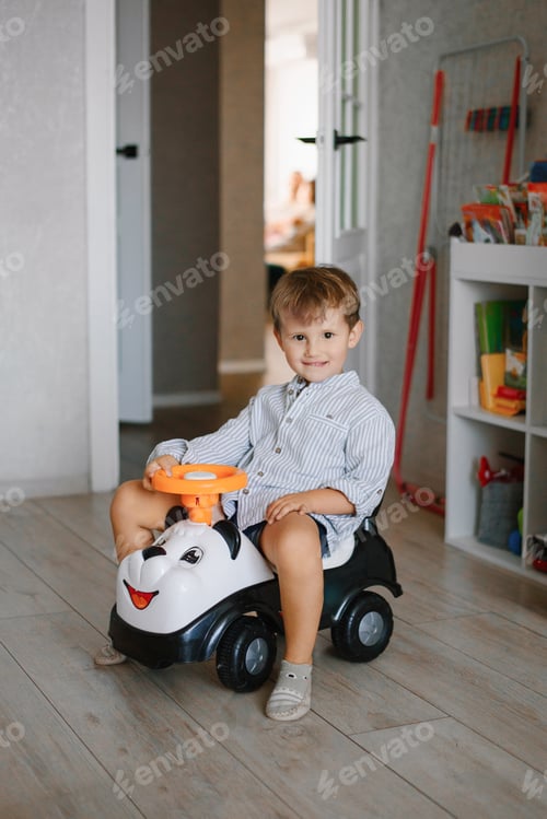 Preview: Happy Toddler Boy Riding Panda Car Toy Indoors