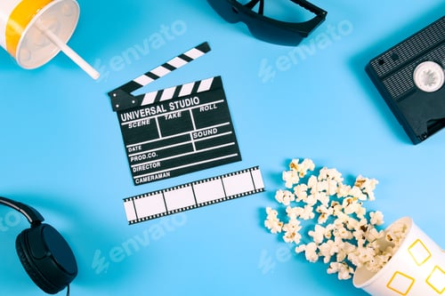 Preview: Movie clapperboard, popcorn, film strip, retro videotape, headphones and paper glass with drink.