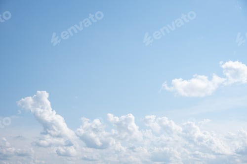 Preview: Blue sky background with white fluffy cumulus clouds. Panorama of white fluffy clouds in blue sky.