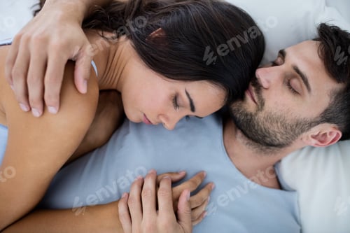 Preview: Young romantic couple sleeping on bed