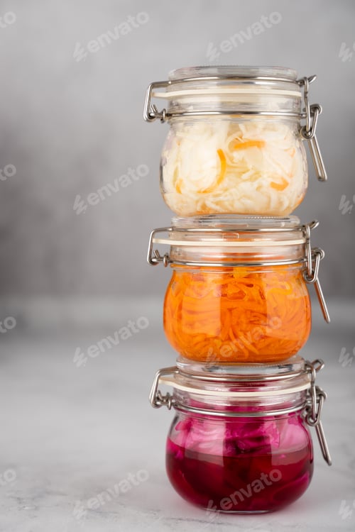 Preview: Homemade village fermented sauerkrauts, red cabbage and korean carrot in glass jars, gray background
