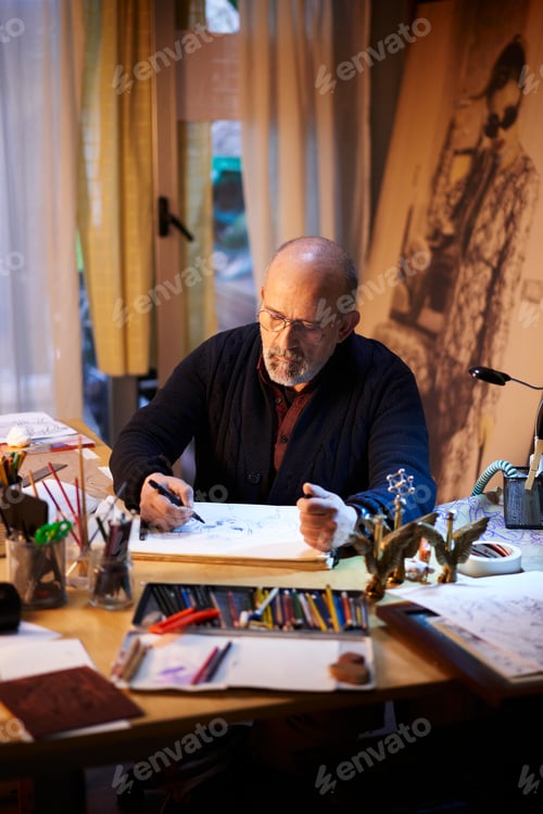 Preview: Artist working in the studio. Middle-aged man making creative artwork.