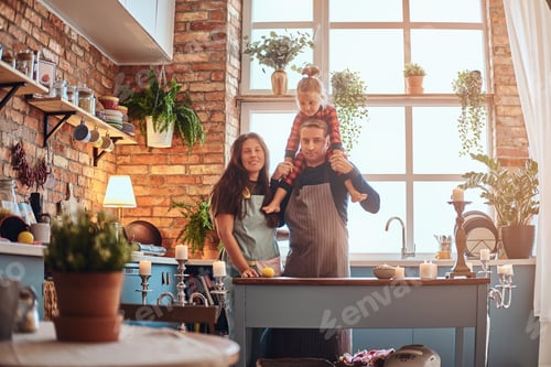 Preview: Mom dad and little daughter together in loft style kitchen at morning.