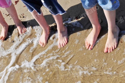 Preview: Children standing in surf at the beach