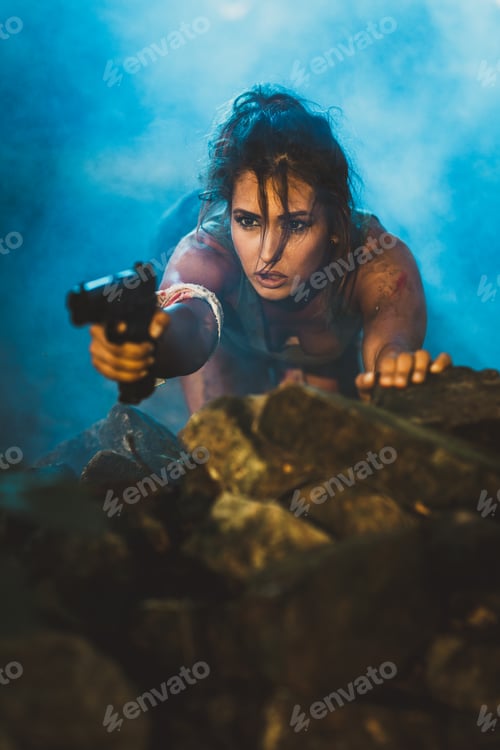 Preview: Woman Shooting With Gun and Squatting on a Rock