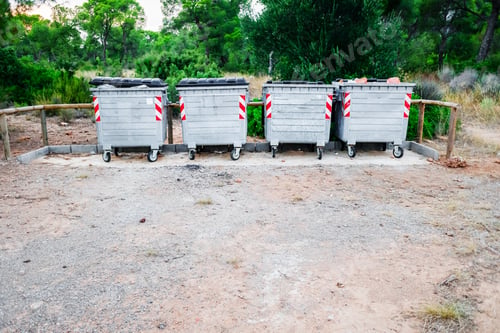 Preview: Metallic garbage containers in a natural recreation area for hikers to deposit their waste.