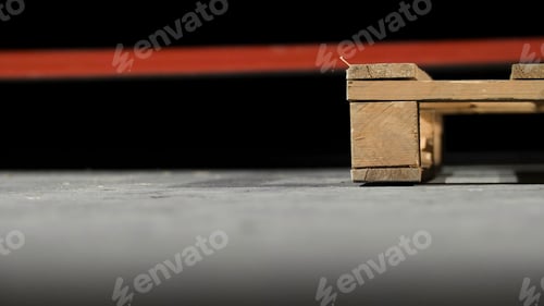 Preview: Close-up of wooden pallet. Angle of wooden pallet on grey concrete floor. Production of furniture