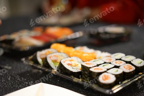 Preview: Sushi takeout/delivery with soy sauce, ginger, wasabi with chopsticks, asia food, asian cuisine.