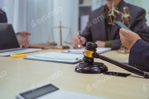 Preview: Three lawyers in a meeting at the table in an office, discussing business,civil and commercial law