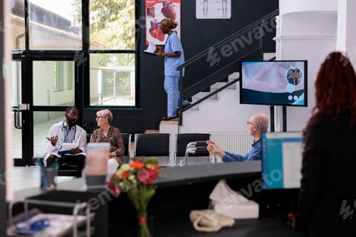 Preview: Physician sitting in hospital area showing disease report to elderly patient during checkup visit