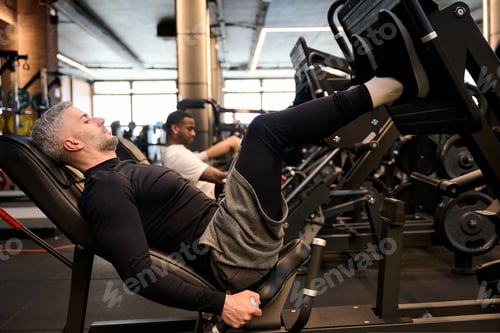 Preview: Man performing leg press exercise in gym