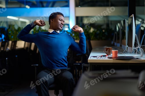 Preview: Drowsy young manager works in night office