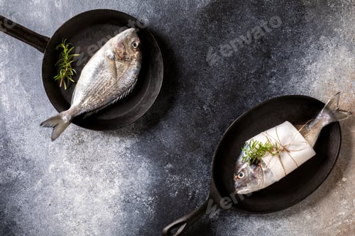 Preview: Fresh uncooked Dorado or sea bream fish in the pan