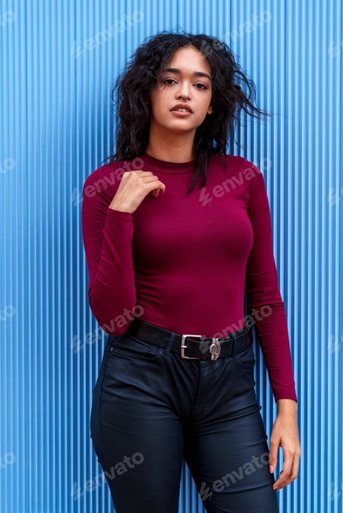 Preview: Elegant, Gorgeous Young Brunette Caucasian Model Posing Against a Vibrantly Blue Wall
