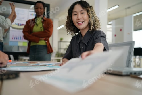 Preview: Happy creative marketing team working on new business project in the office.