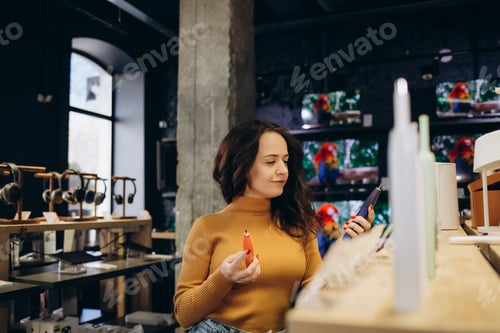 Preview: woman in a store chooses an electric toothbrush brush