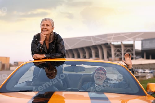Preview: Senior couple enjoying cabriolet ride in city