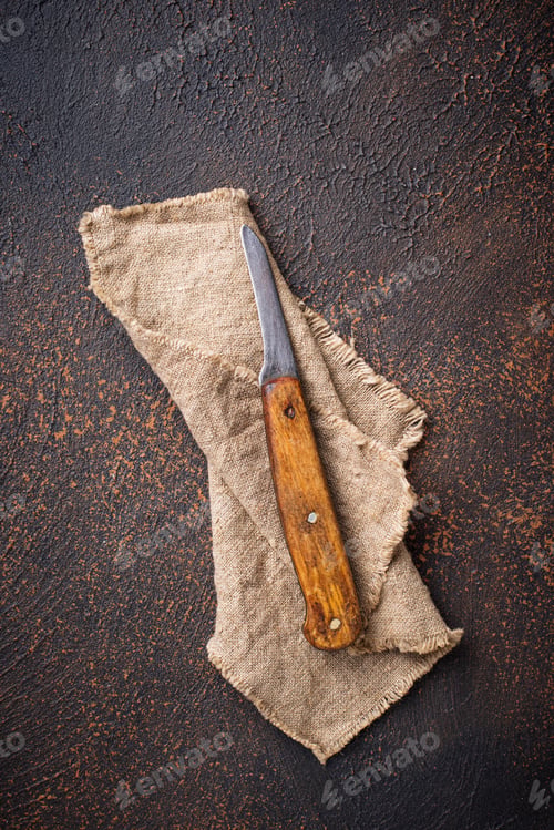 Preview: Old vintage knife on rusty background