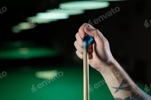 Preview: Close up of a unrecognizable man chalking pool cue