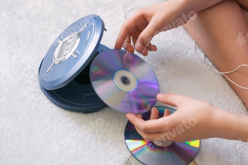 Preview: Girl connects headphones to CD player to listen to music. Recreation entertainment leisure teenager