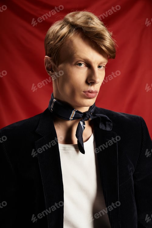 Preview: Young alluring man exudes modern masculinity against a vibrant red backdrop