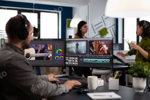 Preview: Videographer listening music on headphones editing creativity movie using post production software