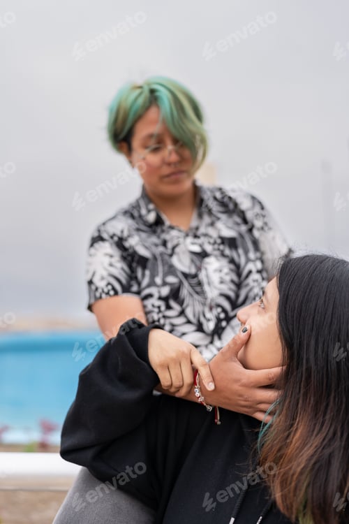 Preview: Lesbian woman caressing her partner's face