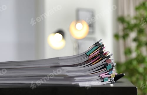 Preview: Stack of documents with paper clips on office table. Space for text