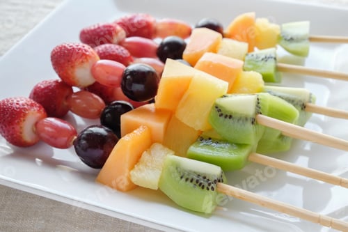 Preview: Colorful and Fresh Fruit Skewers on White Plate