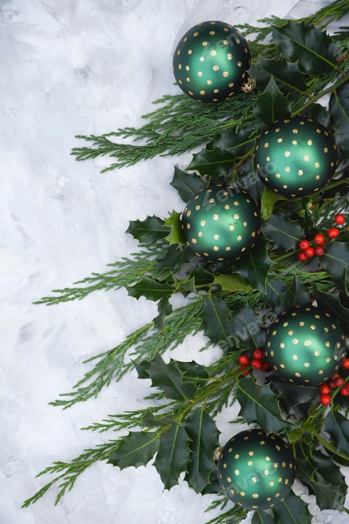 Preview: festive new year table decor with fir branches, holly branches with red berries and green christmas