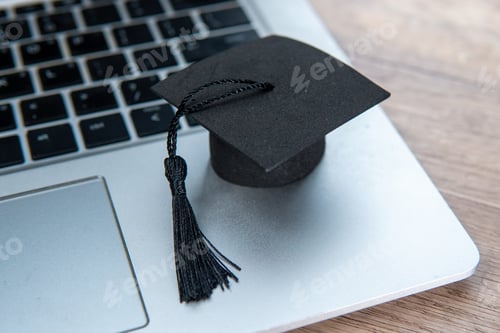 Preview: A graduation cap and a laptop.