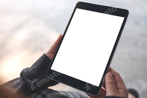 Preview: A woman holding and using black tablet pc with blank white desktop screen