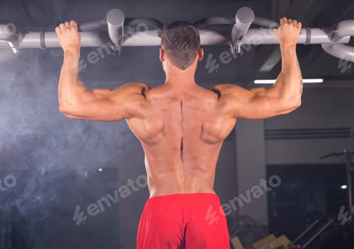 Preview: A young man doing pull ups in the Gym