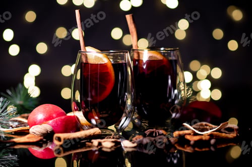 Preview: Christmas mulled wine of red wine with spices and fruits on a black background. Traditional hot drin