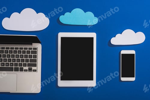 Preview: top view of empty paper clouds near laptop, smartphone and digital tablet with blank screen isolated