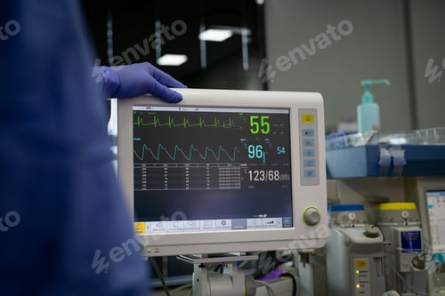Preview: Doctor checking heartbeat and vital sign on monitor