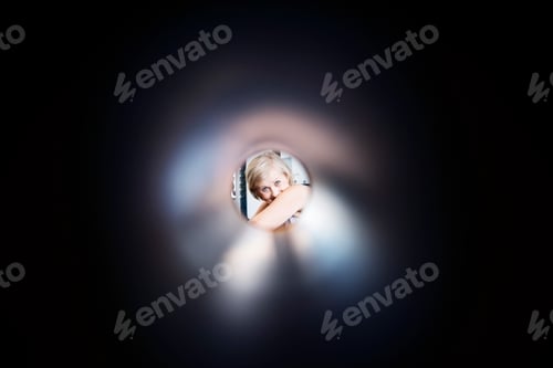 Preview: Fit senior woman in gym, view through foam roller.