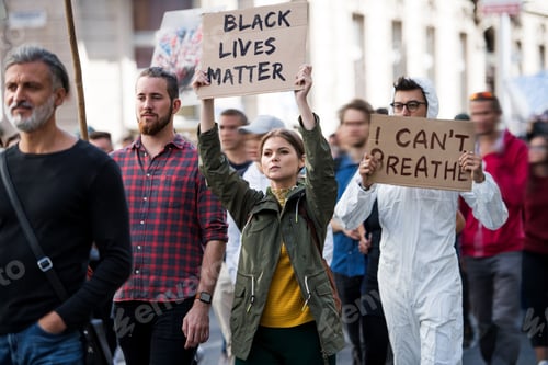 Preview: Black lives matters protesters holding signs and marching outdoors in streets