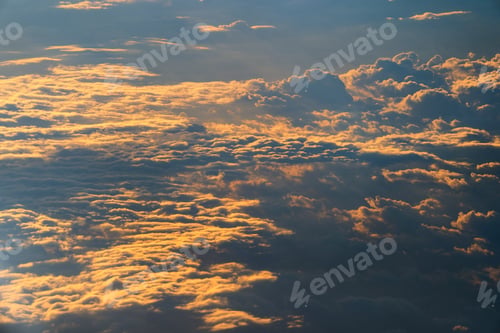 Preview: Sunrise above fluffy clouds from an airplane window with sunlight. Abstract nature background.