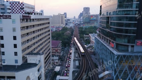 Preview: Wide angle view of elevated monorail train, passing between skyscrapers in Shimbashi Financial