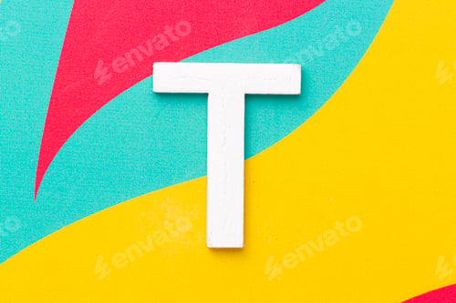 Preview: Letter T of the alphabet on colored background, top view